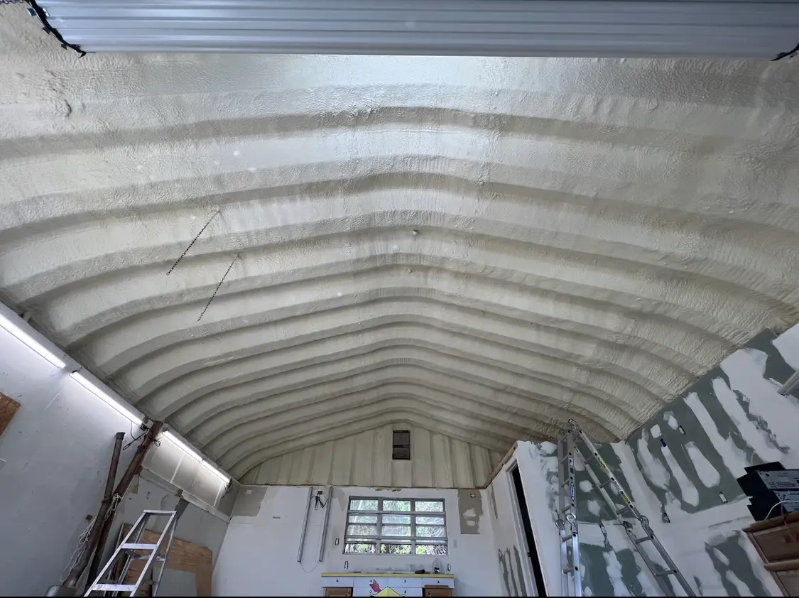 Spray polyurethane foam applied to the underside of a metal roof deck in Knightdale